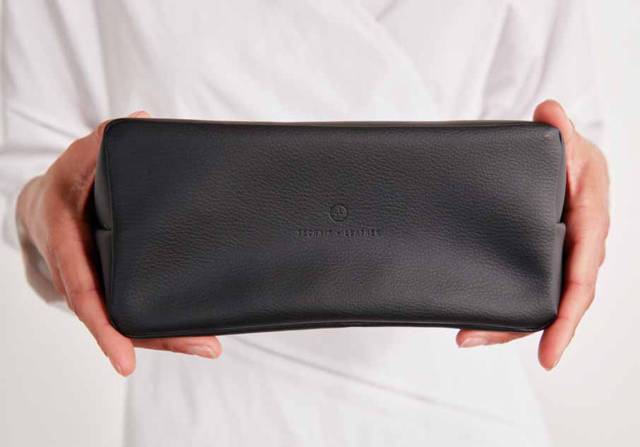 Person's hands holding the accordion pouch