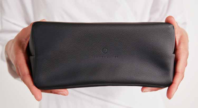 Person's hands holding the accordion pouch