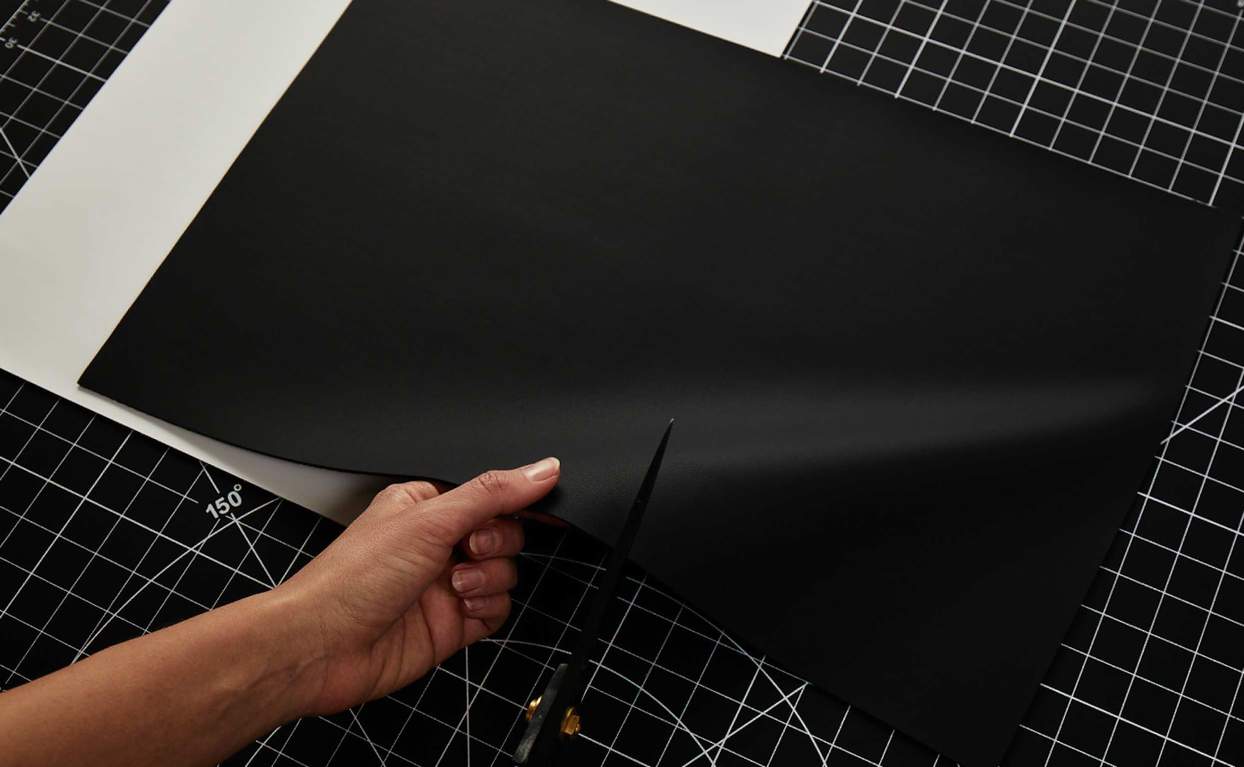 von Holznausen chemist in a lab coat holding a shoe made of Liquidplant in the laboratory