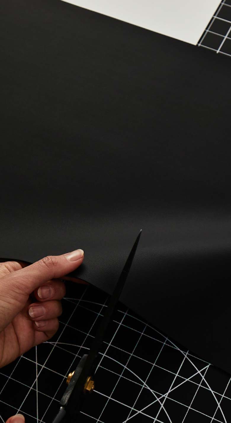 von Holznausen chemist in a lab coat holding a shoe made of Liquidplant in the laboratory