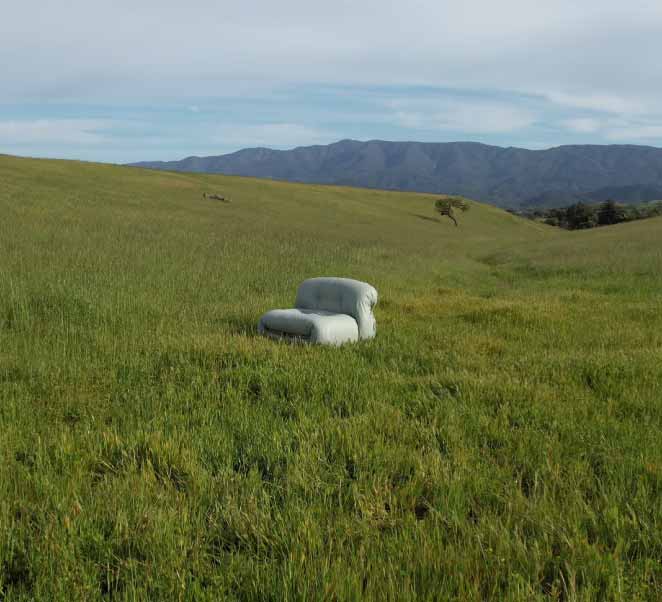 Slide background: The Soriana Chair, upholstered in light green Replant, sitting in the grass on a rolling hill with mountains in the background.