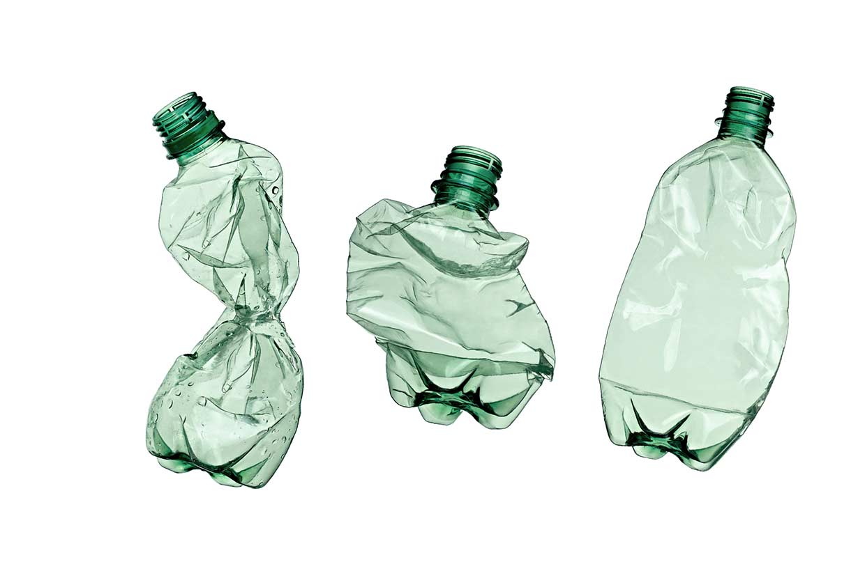 Three crushed plastic water bottles